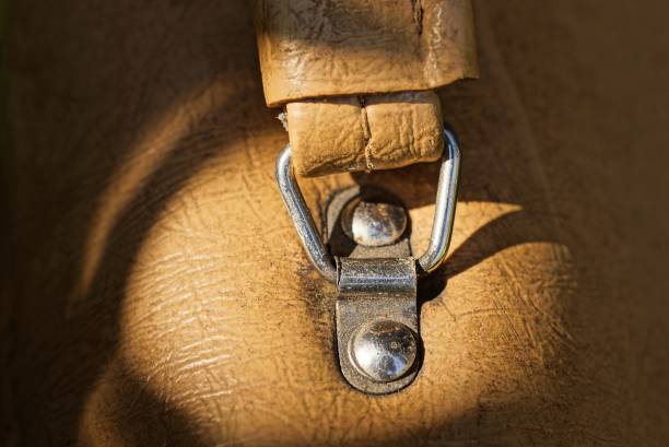 piece of brown briefcase with leather handle and metal gray fasteners