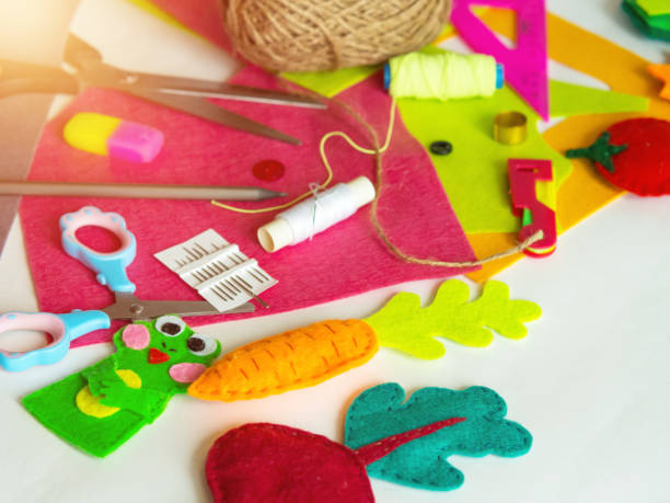 istock Hobby and colorful felt crafts. Workspace view. Sheets and crafts made of felt, scissors, threads and a needle for needlework. 1361107236
