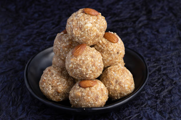 istock Indian traditional sweets or Mithai for Makar Sankranti Or Lohri Gajak or til laddu Also Known As Gur Gajjak, Gazak, Gachak Is Made Of til or sesame seed, Jaggery Gud, Almonds Badam And Pistachio 1361109228