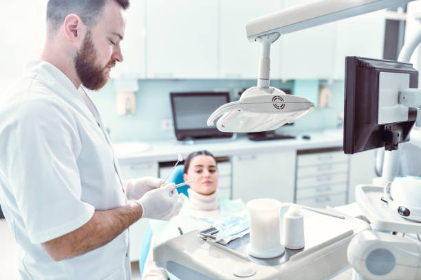 istock Bearded Dentist Preparing Filling For Female Patient 1361120141