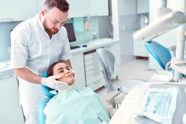 istock Male Dentist Ready To Work On Female Patient 1361120257