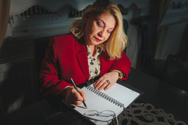 istock Senior businesswoman working late 1361121494