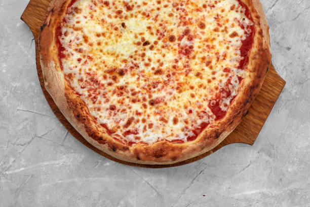 istock Selective focus traditional stone-baked pizza Margarita on stone table 1361122152