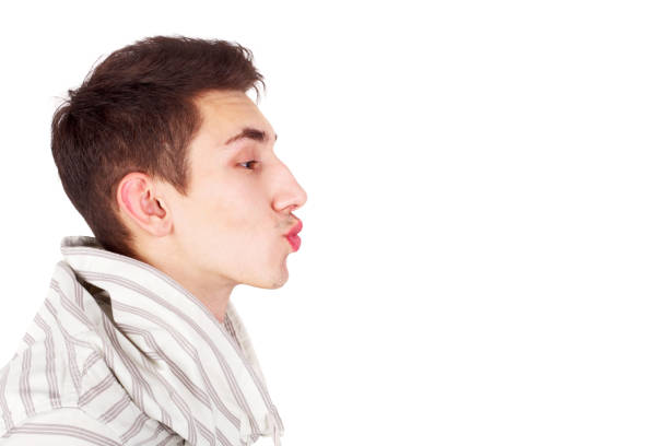 istock Young handsome guy imitating a kiss, copy space 1361125137