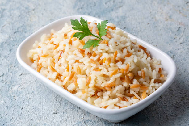 Traditional delicious Turkish food; Turkish style rice pilaf (Turkish name; Arpa sehriyeli pirinc pilavi) Traditional delicious Turkish food; Turkish style rice pilaf (Turkish name; Arpa sehriyeli pirinc pilavi) ARPA stock pictures, royalty-free photos & images