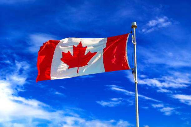 istock Canadian flag against blue sky 1361168263