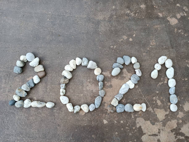 istock The number 2021 is lined with stones on the surface 1361195356
