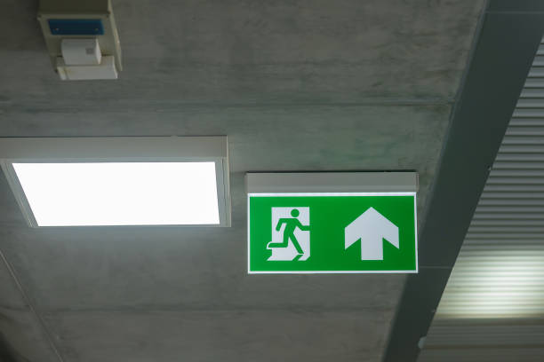 istock Fire Emergency exit sign on the wall inside building at subway train station. Safety concept 1361200136