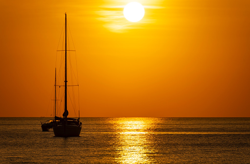 Yacht boat sailing boats or Travel boats in Beautiful phuket sea at sunset golden sky Amazing for summer holiday background and Travel destination or Website Beautiful phuket island