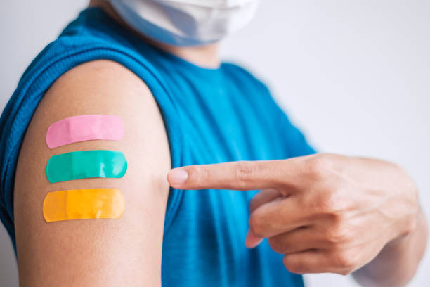 istock Man showing plaster after receiving covid 19 vaccine. Vaccination, herd immunity, side effect, booster dose, vaccine passport and Coronavirus pandemic 1361202640