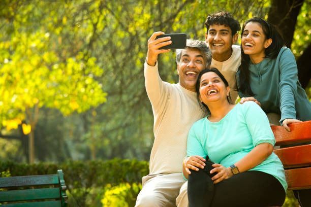 istock Happy family taking selfie using mobile phone camera 1361210351