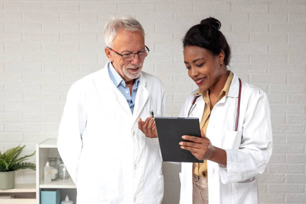 istock Doctors in ambulance looking at tablet and consult about diagnosis 1361212973