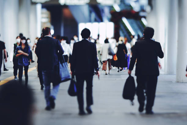 istock Back view of a walking businessman 1361213046