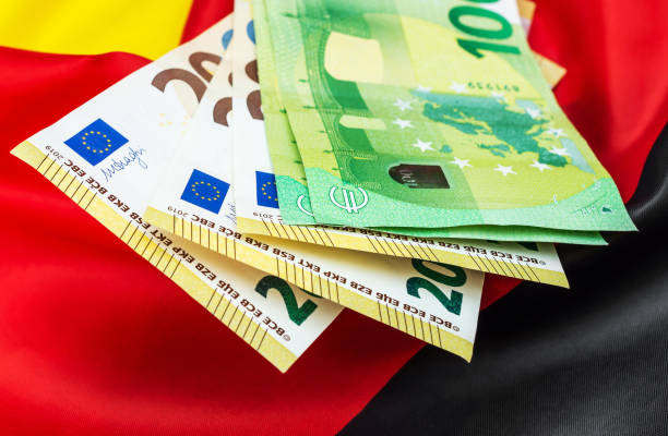 istock Euro bills on German flag. Close up. 1361213310