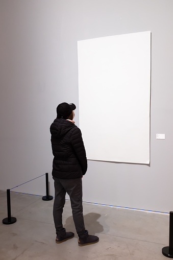 Lady looking at painting in art gallery