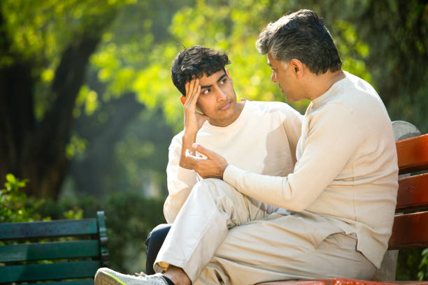 istock Father comforting his son at park 1361214472