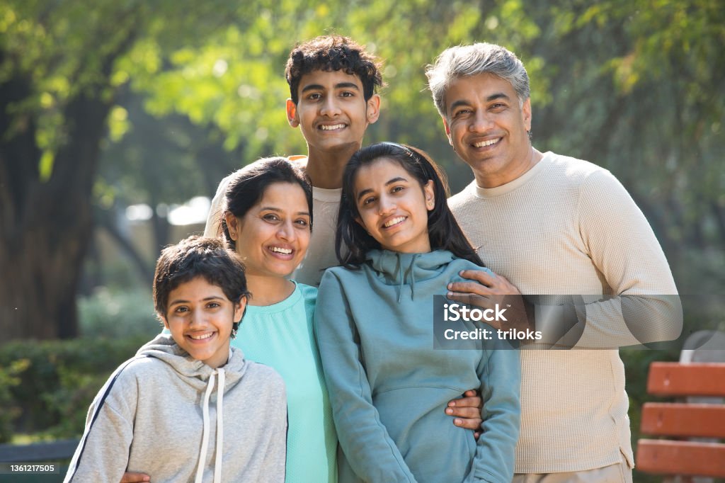 Portrait of happy family having fun at park Family Stock Photo
