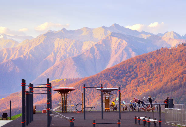 Rosa Khutor, Sochi, Russia, 11.01.2021. Sports ground in the mountains. People are doing fitness surrounded by the autumn mountains of the Caucasus