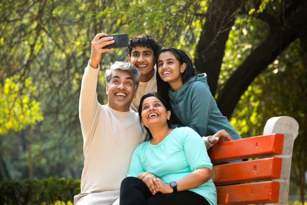 Happy family taking selfie using mobile phone camera