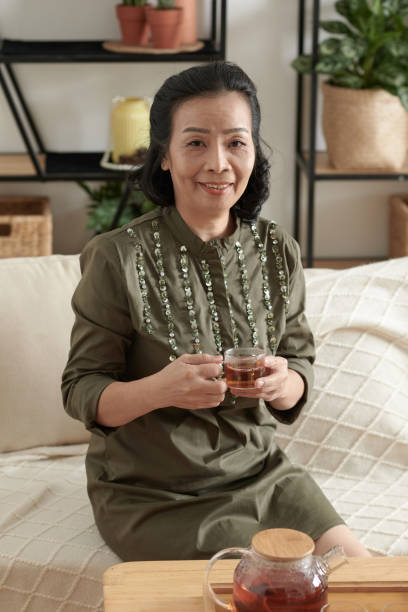 istock Aged Woman Drinking Tea at Home 1361217645