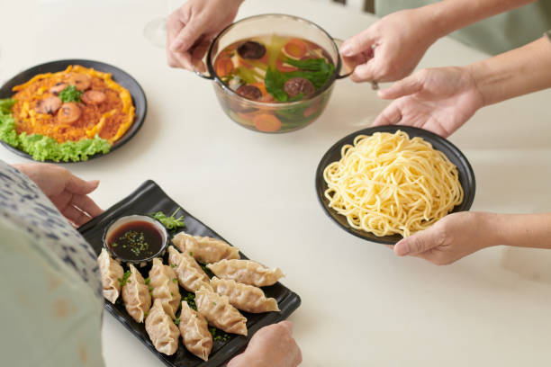 istock Friends Seving Food for Dinner 1361217697