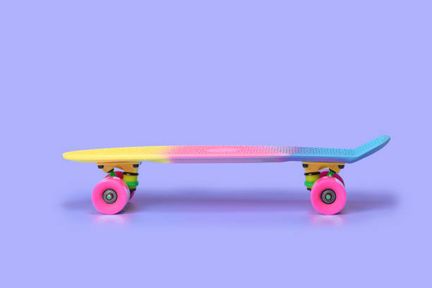 istock rainbow plastic Penny board skateboard isolated on purple background 1361235354