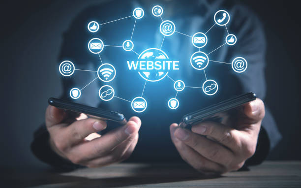 istock Man holding smartphones. Website concept 1361246389