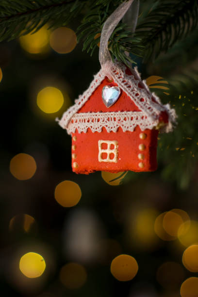 istock House figurine handmade salt dough toy on Christmas tree. 1361249301