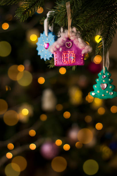 Handmade salt dough toys on Christmas tree. Holiday background.