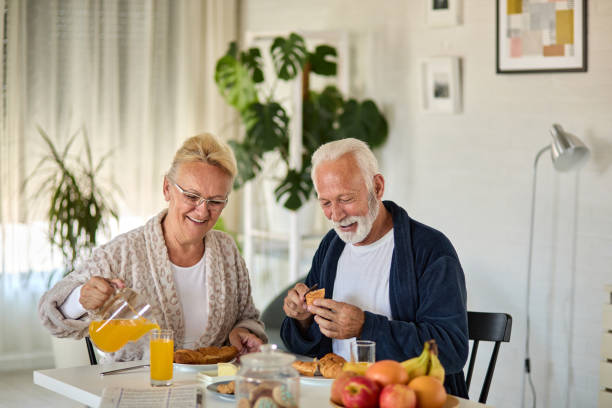 istock Beautiful senior couple having breakfast at home 1361250035