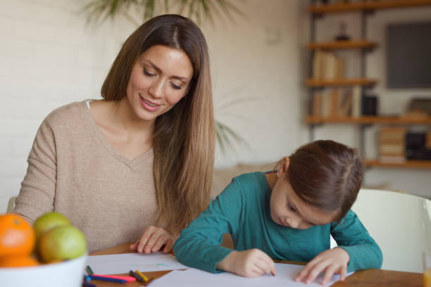 istock Mother spending quality time with her daughter teaching her to draw 1361250131
