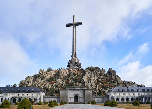 Madrid, Spain; 4th December 2021: cross above the rocky mountain and the Abbey of the Valley of the Fallen