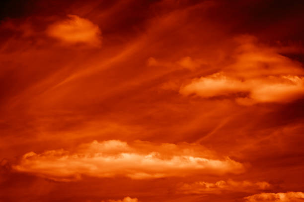 istock Red orange dramatic fire sky with black clouds and yellow sunlight at sunset before bad weather storm, fantastic natural background 1361252409