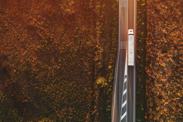 Top view of truck on the road, aerial shot Top view of truck on the road, aerial shot from drone pov drone point of view road stock pictures, royalty-free photos & images