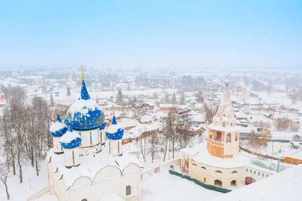 Aerial drone view of Suzdal Kremlin and cathedral of Nativity at the Kamenka river, Russia during winter with snow. Suzdal golden ring of Russia.
