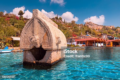 istock Ancient sunken tomb of the Lycian Greek civilization on the shores of the Mediterranean Sea near the island of Kekova in Turkey. Travel attractions and wonders 1361261137