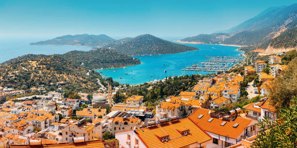 Majestic panoramic view of seaside resort city of Kas in Turkey. Romantic harbour with yachts and boats. Villas and hotels with red roofs are open for tourists Majestic panoramic view of seaside resort city of Kas in Turkey. Romantic harbour with yachts and boats. Villas and hotels with red roofs are open for tourists french riviera stock pictures, royalty-free photos & images