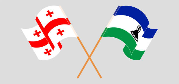 Crossed and waving flags of Georgia and Kingdom of Lesotho Crossed and waving flags of Georgia and Kingdom of Lesotho. Vector illustration georgia football stock illustrations