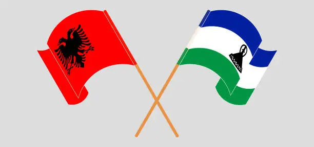 Vector illustration of Crossed and waving flags of Albania and Kingdom of Lesotho