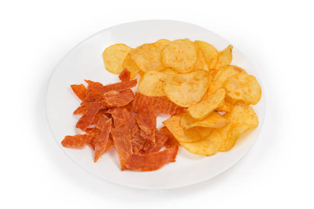 istock Dry chicken snacks and potato chips on a white dish 1361264845