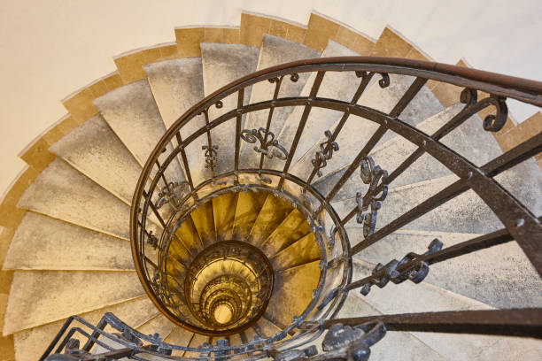 istock Spiral staircase made with stone and iron handrail. Classic building 1361269405