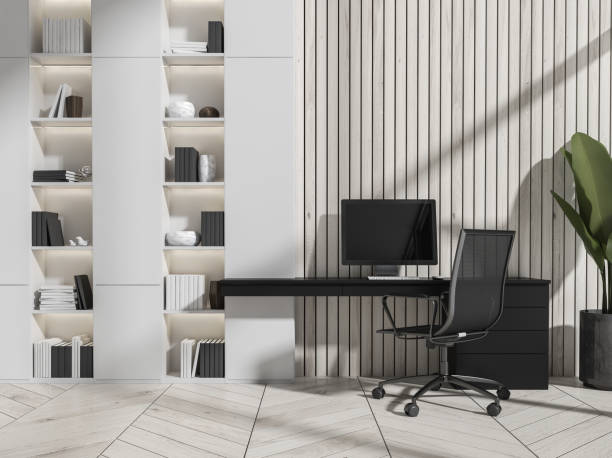 istock Business interior, armchair and table with computer and bookshelf. Copy space 1361272390