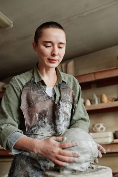 istock Woman creating clay sculpture in workshop 1361273097