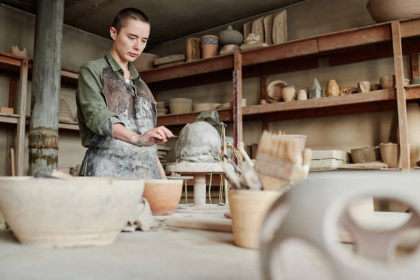 istock Woman creating ceramic vase from clay 1361273127