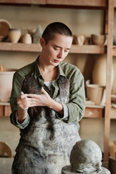istock Female pottery artist in her art studio 1361273139
