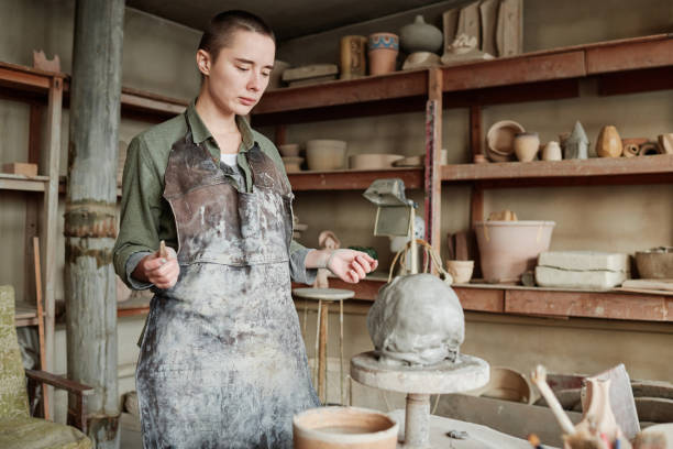 istock Woman learning to make sculpture from clay 1361273154