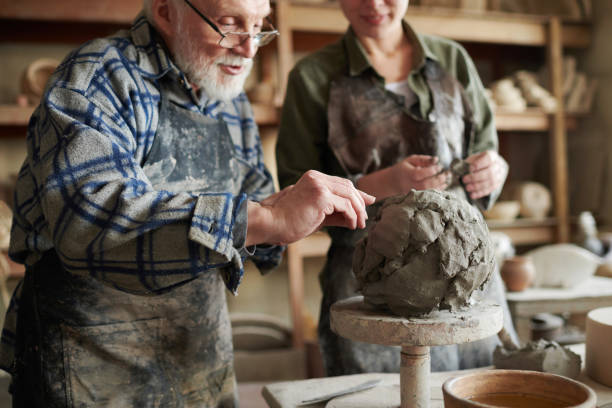 istock Potter holding the pottery lesson 1361273195