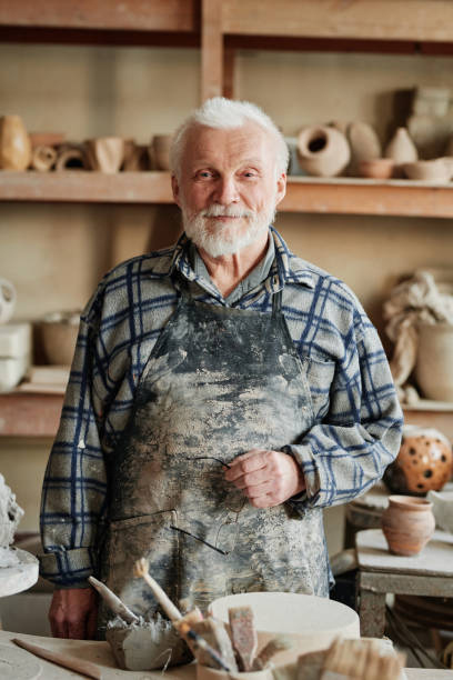 istock Senior ceramist working with clay 1361273216
