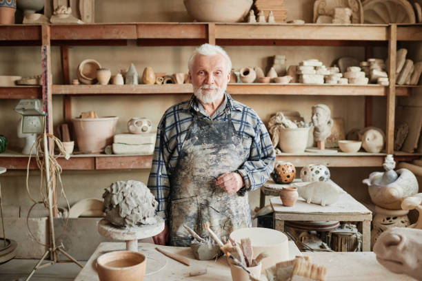 istock Senior potter making sculptures from clay 1361273225