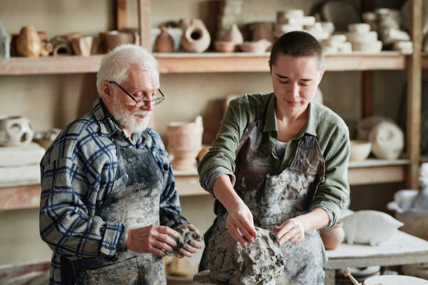 istock Woman learning to sculpt from clay 1361273289